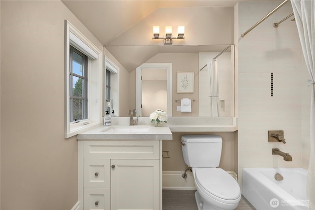 bathroom with shower / bathtub combination, vanity, baseboards, toilet, and lofted ceiling