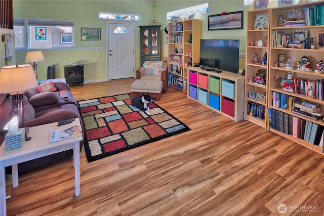 living area featuring a wood stove and wood finished floors