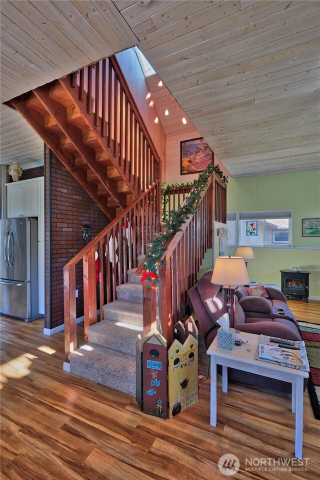 living room with stairs, wooden ceiling, vaulted ceiling, and wood finished floors