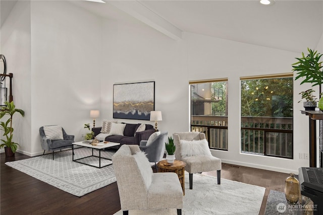 living room featuring heating unit, beam ceiling, high vaulted ceiling, and wood finished floors