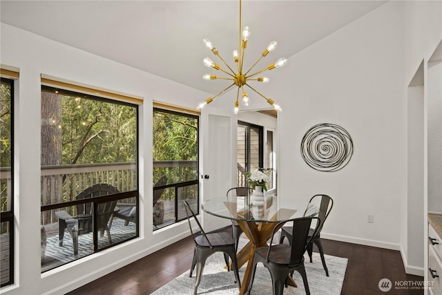 dining room with plenty of natural light, a chandelier, and dark wood finished floors