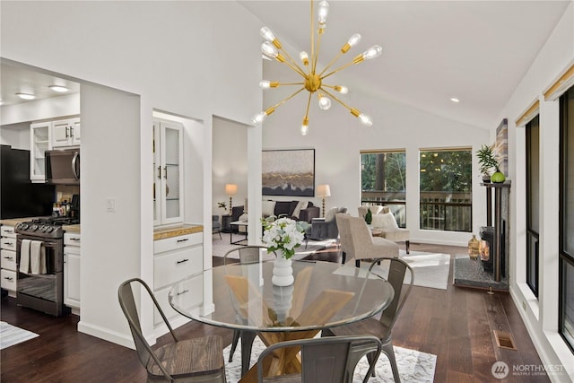 dining space featuring high vaulted ceiling, dark wood-style floors, visible vents, and a notable chandelier