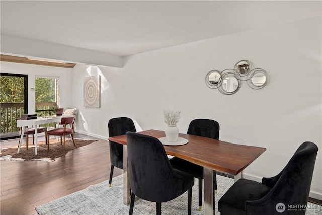 dining area featuring baseboards and wood finished floors