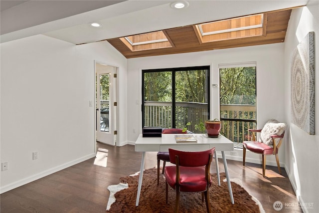 dining room with dark wood finished floors, a wealth of natural light, and baseboards