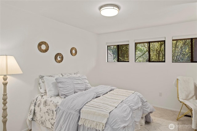 carpeted bedroom featuring baseboards