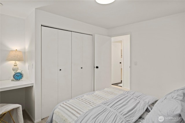 bedroom featuring a closet and light carpet