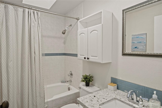 full bath with tiled shower / bath, toilet, and vanity