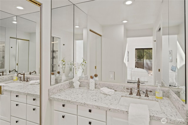 bathroom with connected bathroom, vanity, and recessed lighting