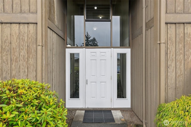 view of exterior entry featuring board and batten siding