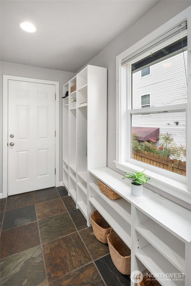 mudroom with stone tile floors