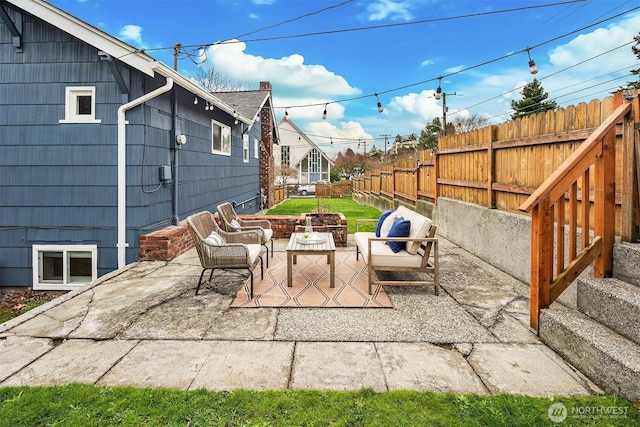 view of patio / terrace with an outdoor living space with a fire pit and fence