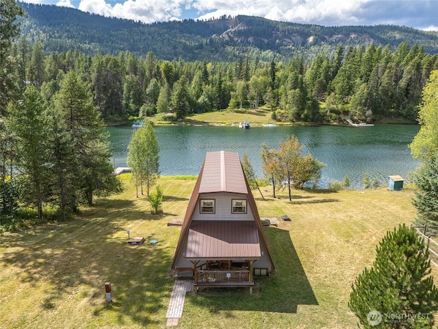 birds eye view of property with a forest view and a water view