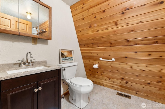 bathroom featuring visible vents, vanity, and toilet