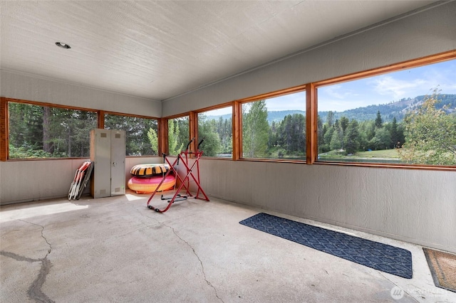 unfurnished sunroom with a view of trees