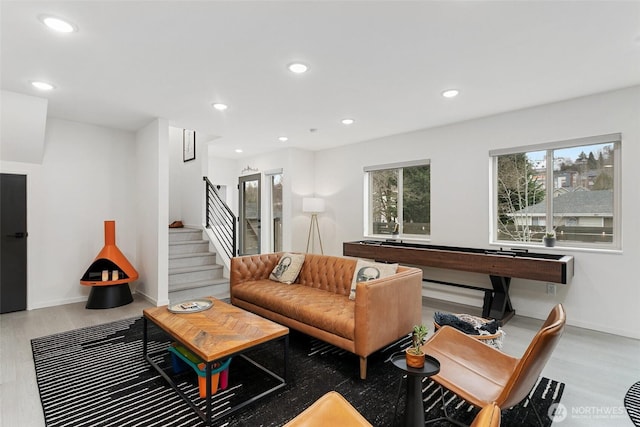 living room with stairs, recessed lighting, baseboards, and wood finished floors