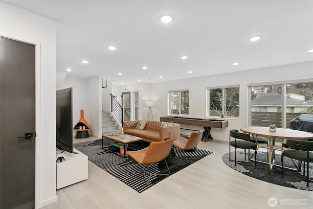 living area featuring stairs, wood finished floors, and recessed lighting