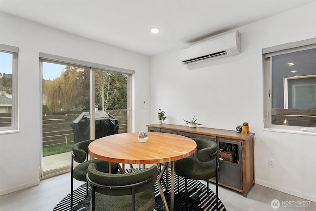 dining room featuring recessed lighting, a wall mounted air conditioner, and baseboards