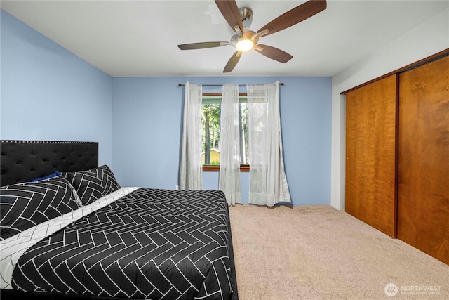 carpeted bedroom with a closet and a ceiling fan