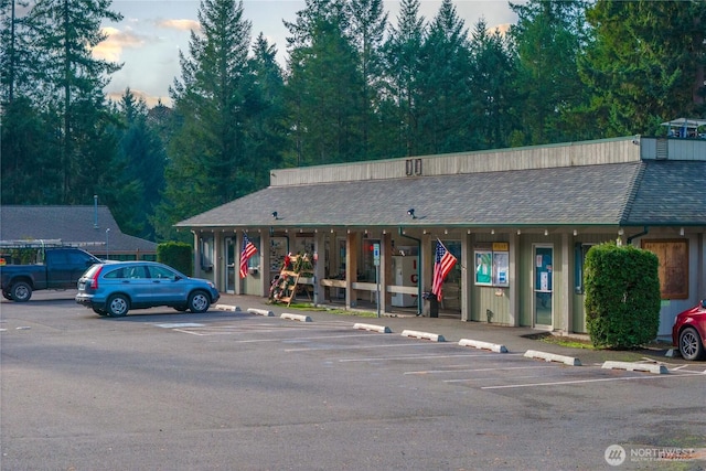 view of building exterior featuring uncovered parking