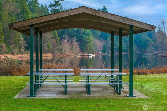 view of community featuring a water view and a lawn