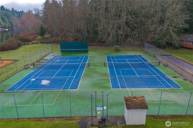 view of sport court featuring fence