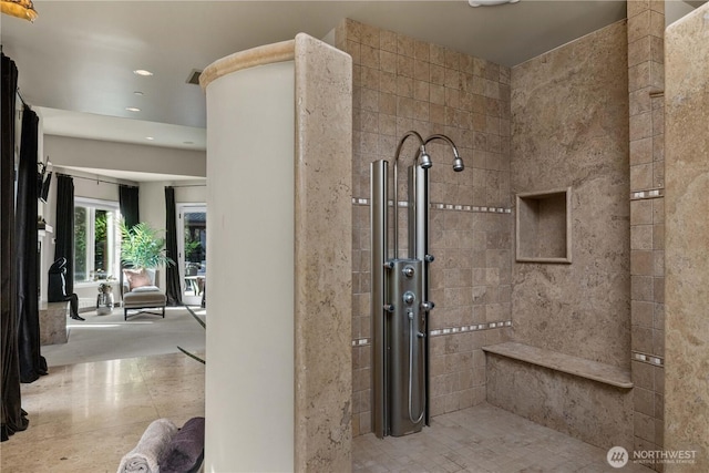 full bath featuring a tile shower and recessed lighting