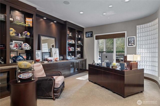 office with recessed lighting and light colored carpet