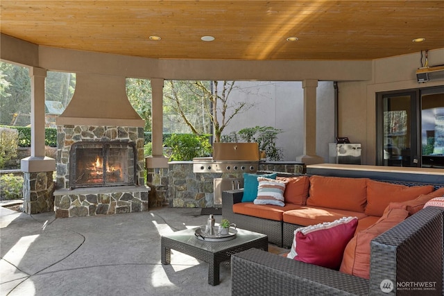 view of patio / terrace featuring an outdoor living space with a fireplace and area for grilling