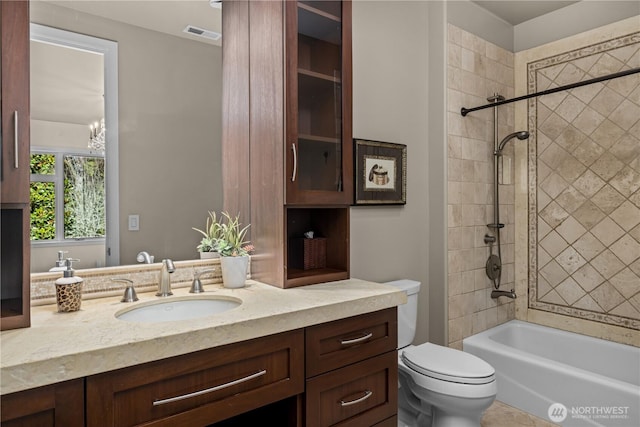 bathroom featuring shower / washtub combination, visible vents, vanity, and toilet