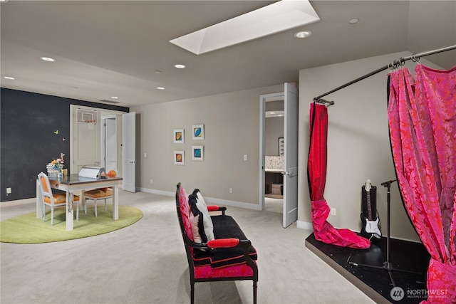 interior space with a skylight, recessed lighting, baseboards, and light colored carpet