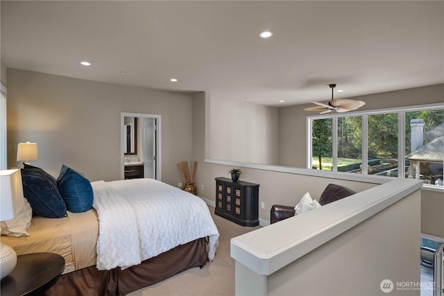 carpeted bedroom featuring recessed lighting, ensuite bath, and baseboards