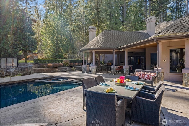 view of pool featuring a fenced in pool, outdoor dining space, a patio area, and an in ground hot tub