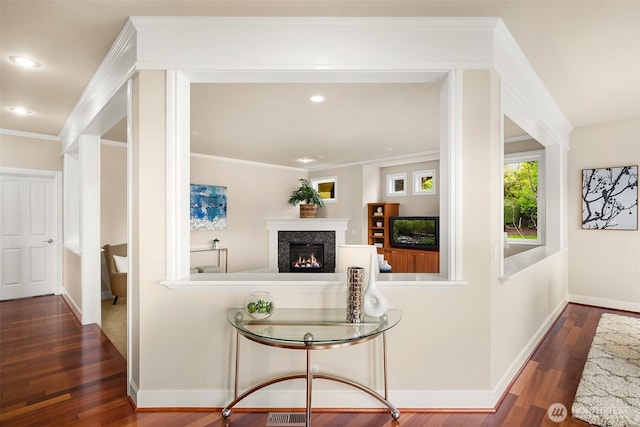 hallway featuring recessed lighting, baseboards, wood-type flooring, and ornamental molding