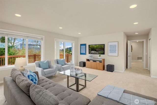 living room with recessed lighting, visible vents, baseboards, and carpet