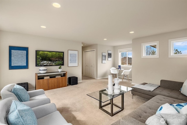 living area featuring recessed lighting, baseboards, and light carpet