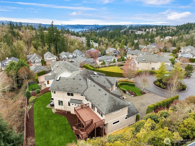 drone / aerial view with a view of trees and a residential view