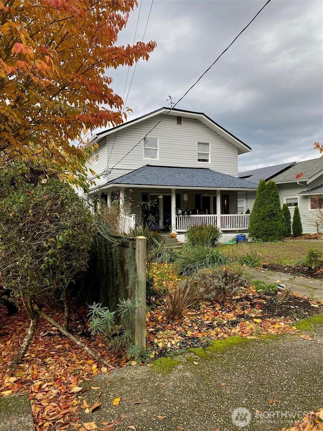 view of front of home with a shingled roof and covered porch