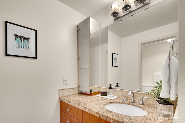 bathroom with tasteful backsplash and vanity