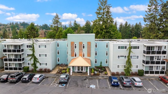 view of building exterior featuring uncovered parking