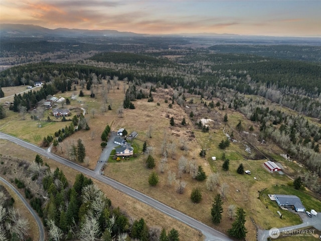 aerial view at dusk featuring a mountain view