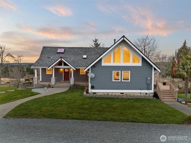 view of front of property featuring a front lawn and a shingled roof