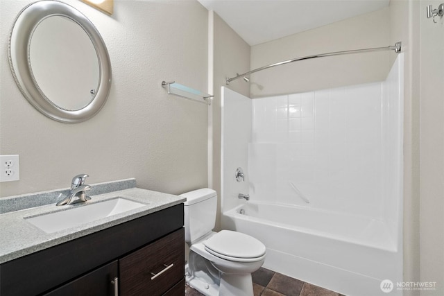 bathroom with tub / shower combination, vanity, and toilet