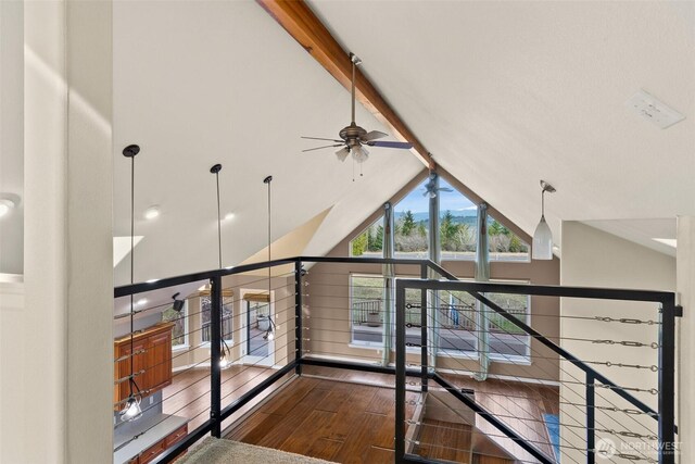 hall with high vaulted ceiling, beamed ceiling, and wood finished floors