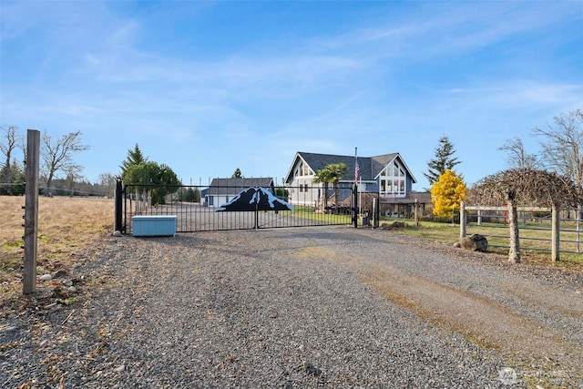 view of road featuring a gate, driveway, and a gated entry