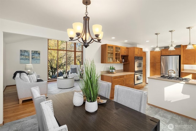 dining room featuring a chandelier and recessed lighting