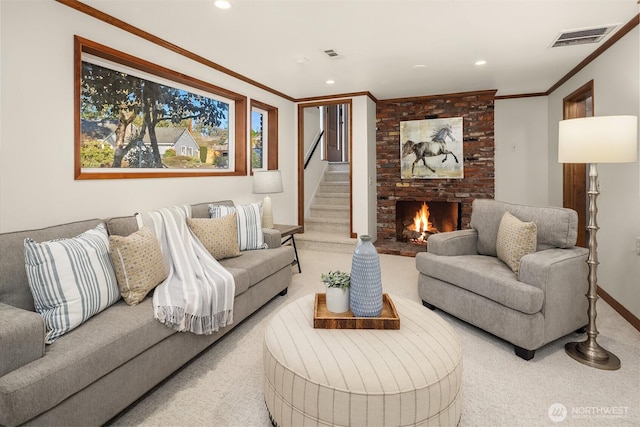 living room featuring a brick fireplace, visible vents, crown molding, and carpet flooring