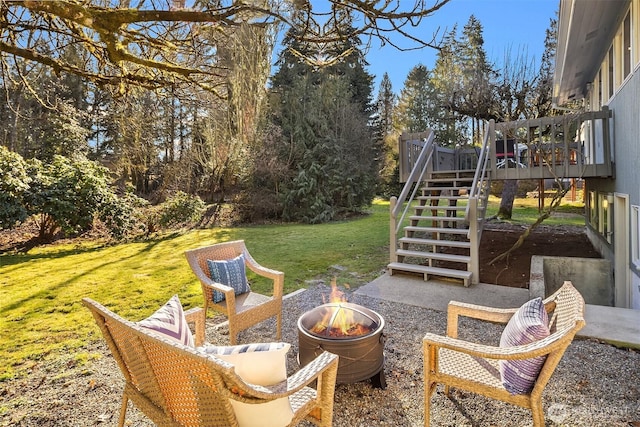 view of patio featuring stairs, a deck, and a fire pit