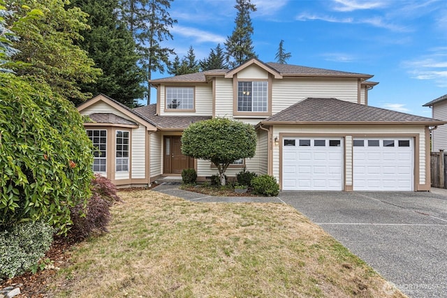 traditional-style house featuring a garage, roof with shingles, aphalt driveway, and a front yard