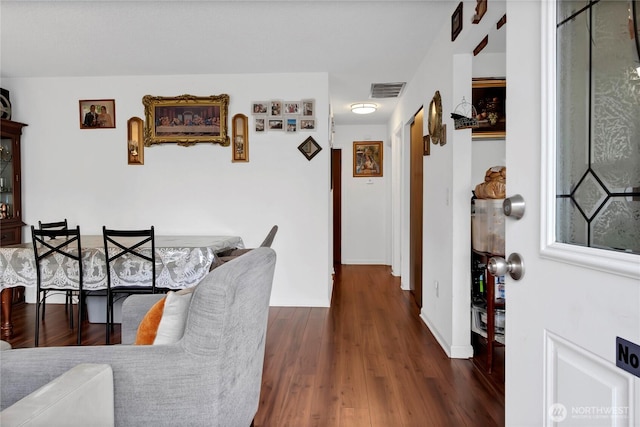 interior space with baseboards, visible vents, and wood finished floors