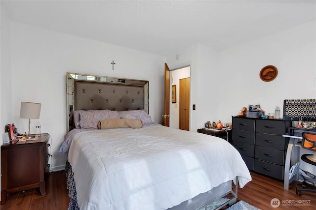 bedroom with dark wood finished floors